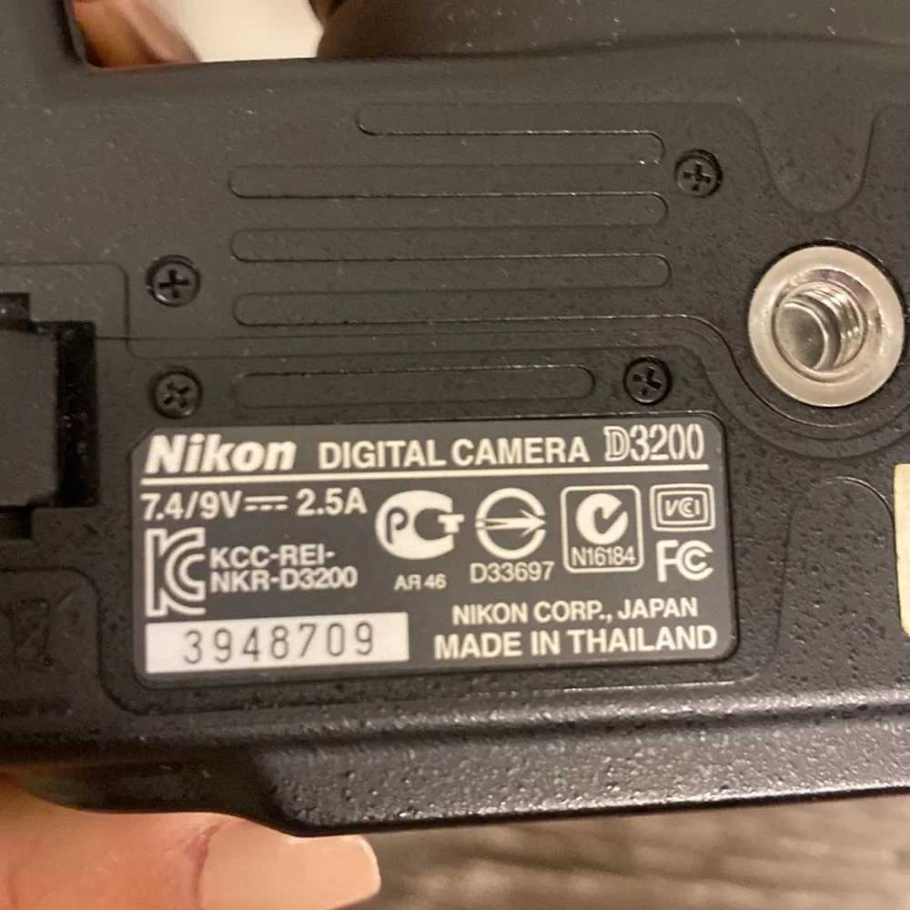 Nikon D3200 camera with battery pack and 55-200 mm lense